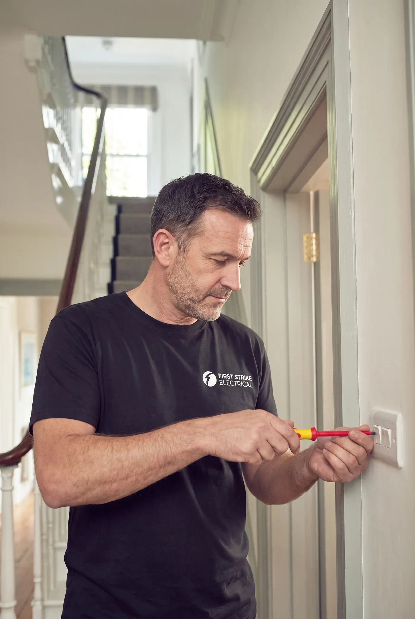 Domestic electrician working on a home installation in London